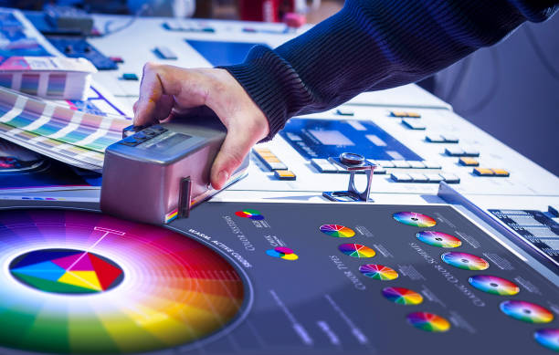 Young man in the process of offset printing and color correction